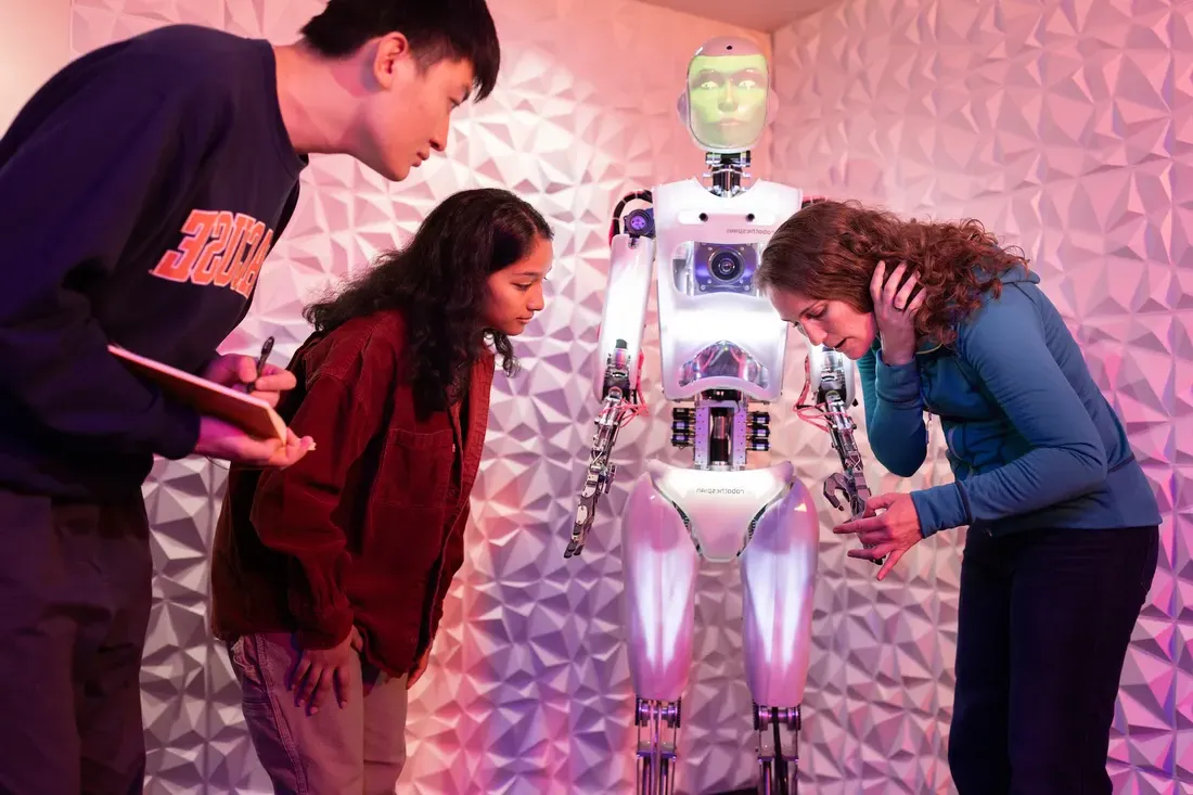 Students work with Professor Jamie Banks and their AI robot Ray, to reserach AI technology in the Link lab in Hinds Hall.