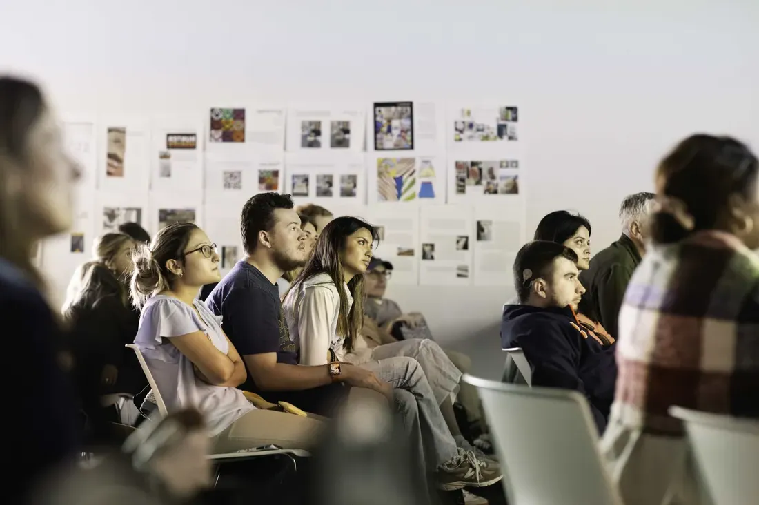 Students in a classroom listening to a presentation in a classroom.